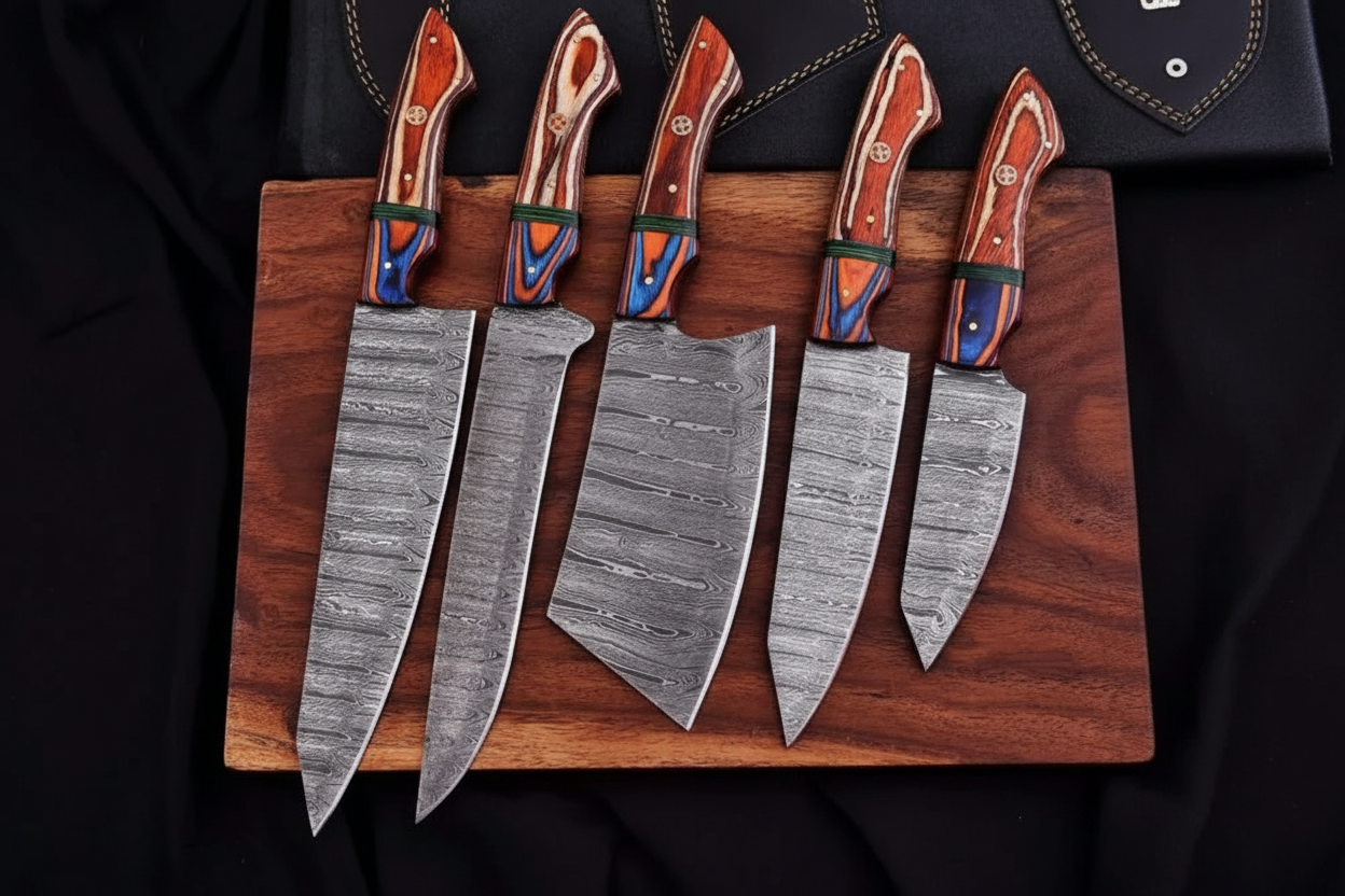 Damascus steel knife set flat lay on wooden board